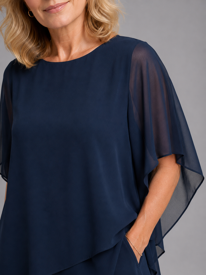 Navy blue women's chiffon two-piece set featuring a flutter sleeve top & wide leg pants. Ideal for events.