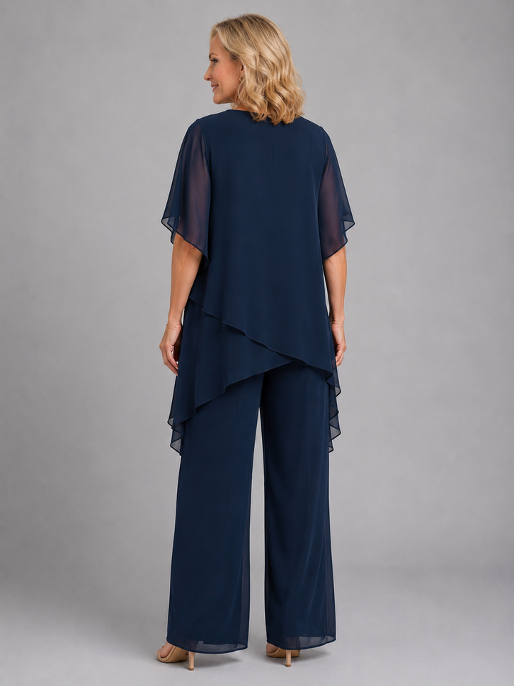 Chic pink chiffon two-piece women's outfit with comfortable wide-leg pants & a flowy top. Relaxed elegance.