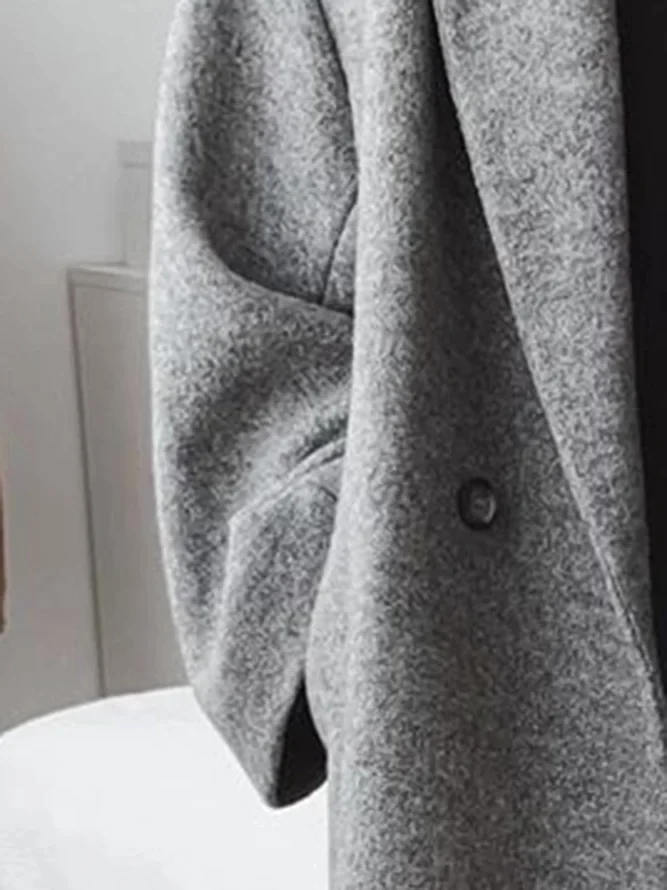 Long women's classic tailored overcoat in grey for autumn & winter, elegant outerwear for ladies.