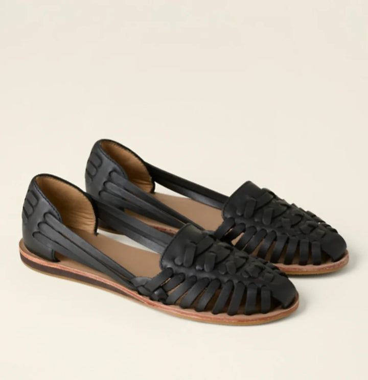 Elegant women's closed-toe flat sandals with woven detail; stylish slip-on d'Orsay comfort footwear for summer.