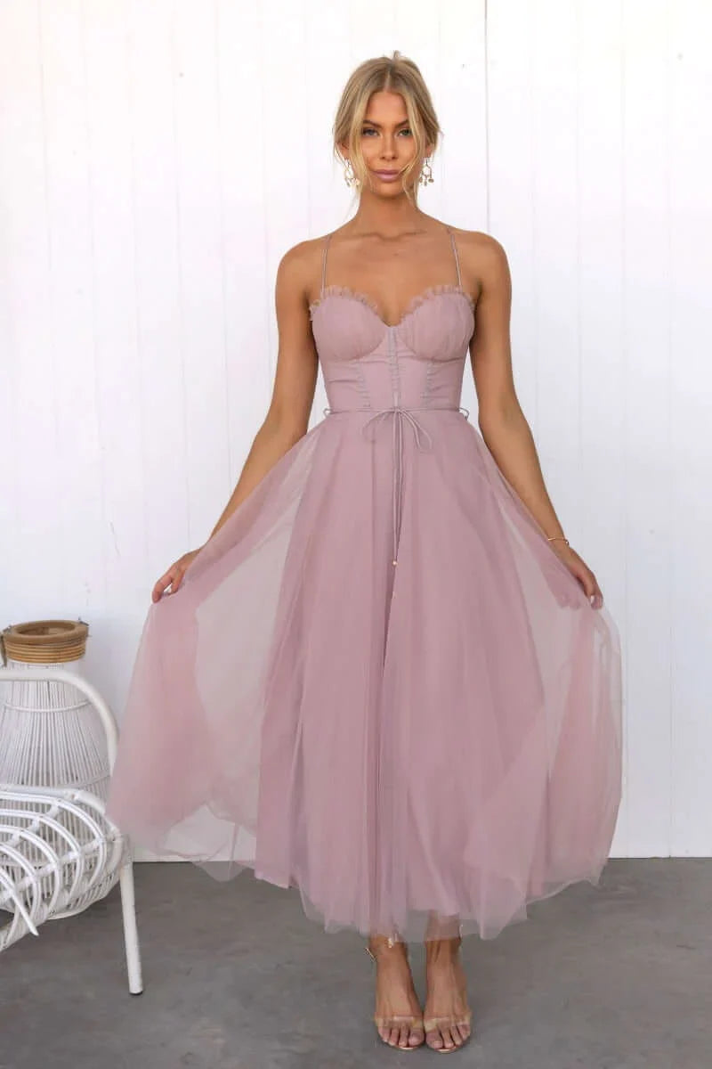 Chic party dress featuring a flattering corset bodice and a whimsical tulle midi skirt.