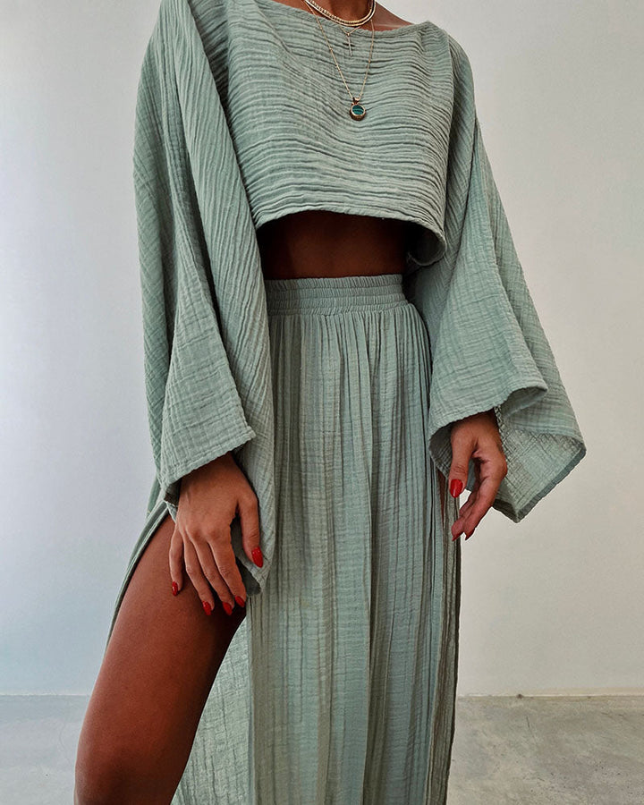 Chic women's co-ord set featuring a long sleeve crop top & elegant side split maxi skirt. Stylish two-piece.