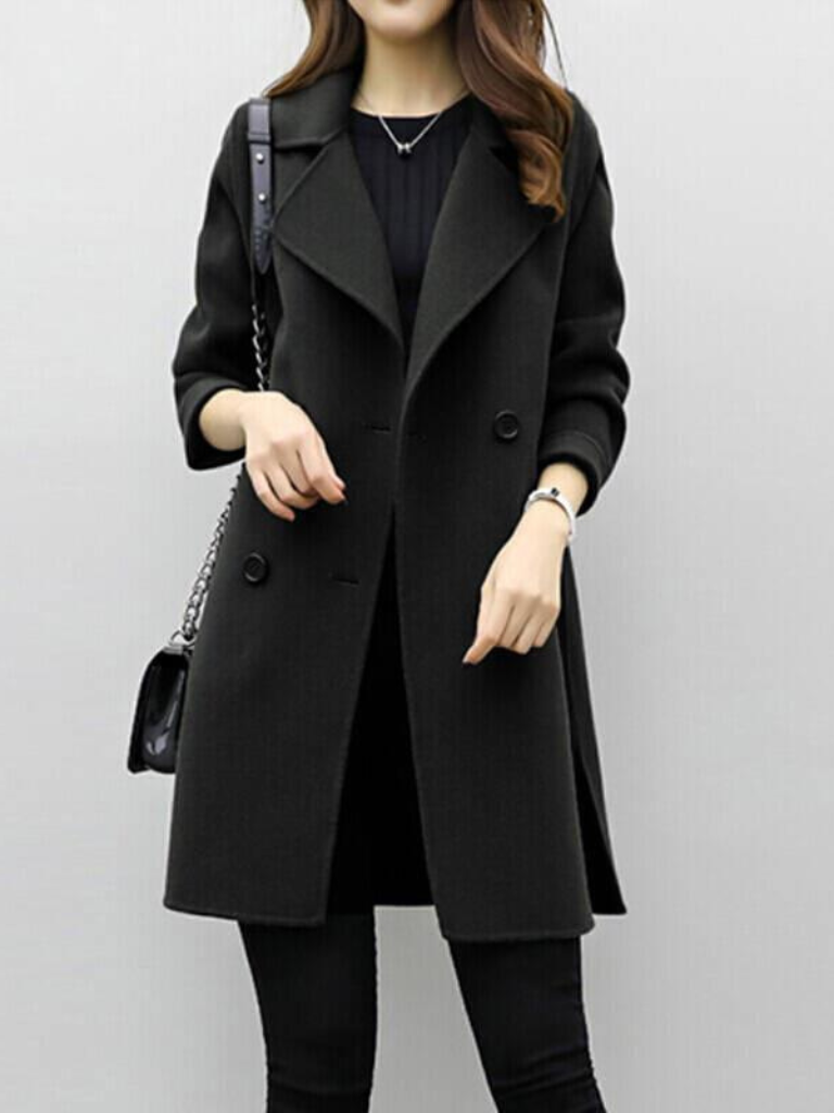 Modern women's double-breasted longline coat profile. Sophisticated & versatile outerwear.