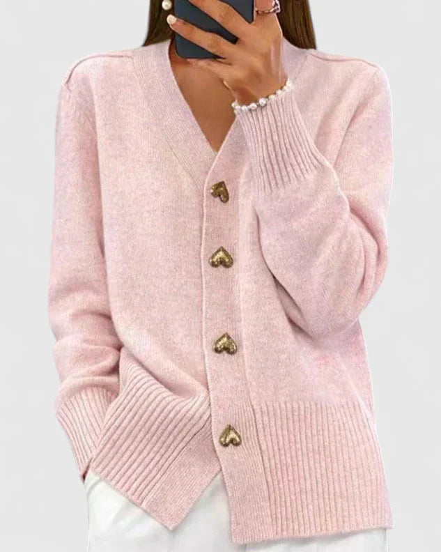 Stylish women's cardigan sweater with unique charm buttons and an elegant draped design.