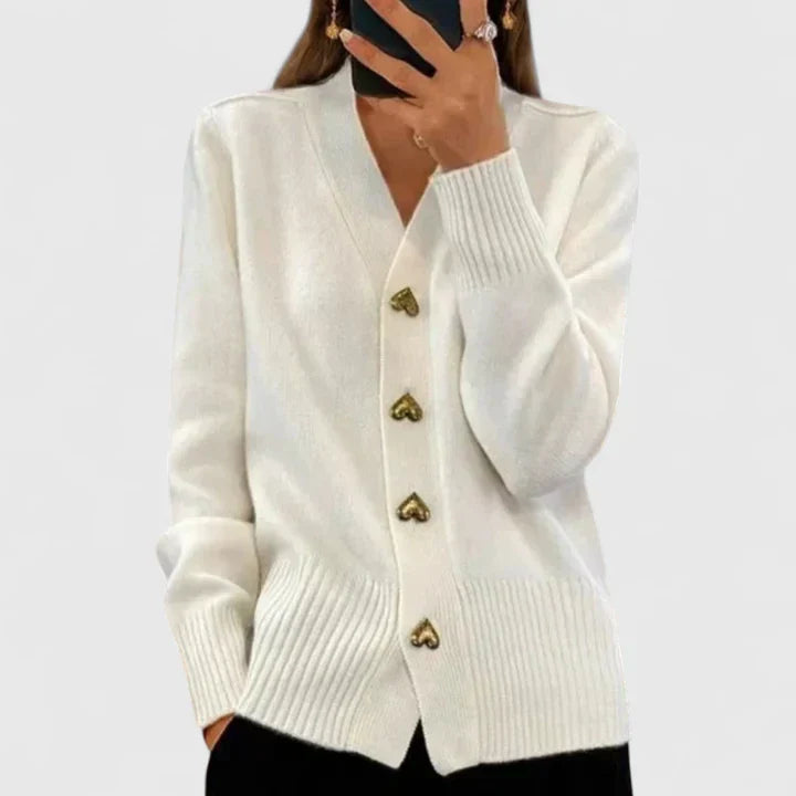 Soft women's long-sleeve cardigan sweater, designed with an elegant drape and charming buttons.