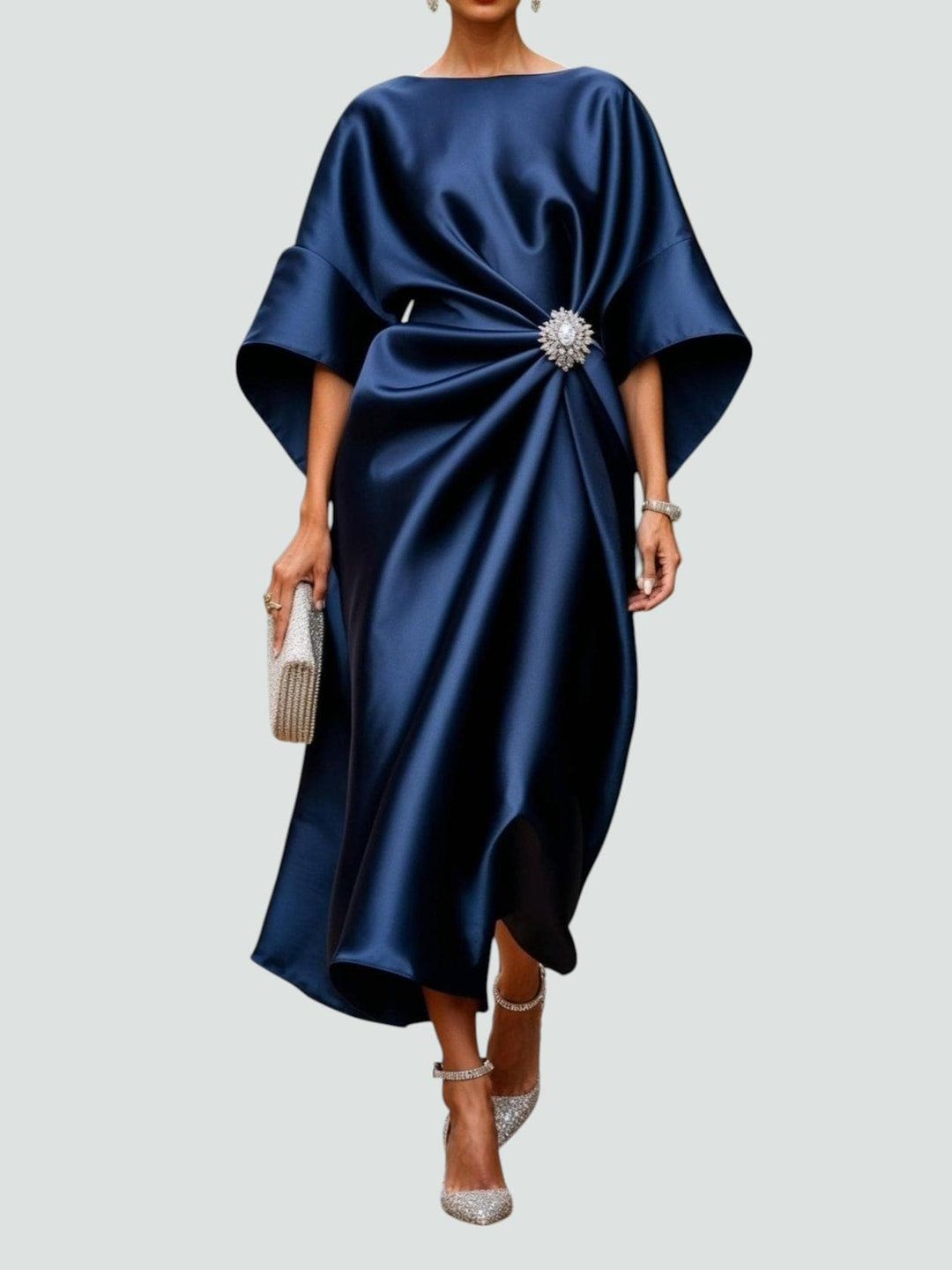 Elegant women's draped maxi dress with sophisticated brooch detail, perfect for evening or special occasions.
