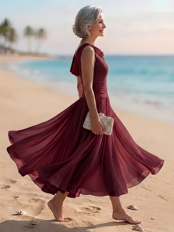 Chic A-line pleated midi dress for women, featuring a flattering draped neck, perfect for wedding attendees.