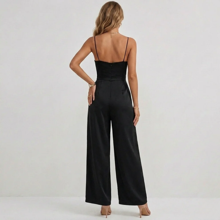 Chic women's jumpsuit featuring intricate draping and stylish pleats on a high-waisted wide-leg silhouette.