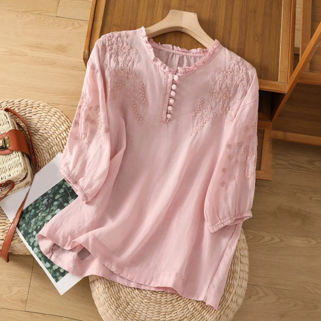 Versatile women's button-front blouse with delicate embroidery and 3/4 sleeves for summer fashion.