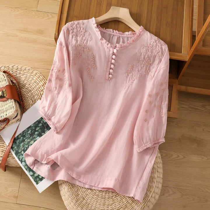 Versatile women's button-front blouse with delicate embroidery and 3/4 sleeves for summer fashion.