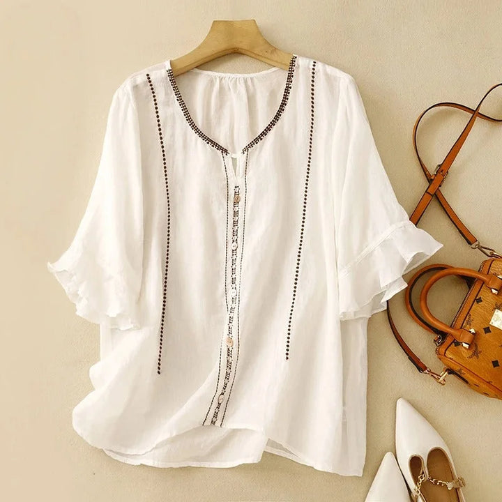 Elegant women's embroidered blouse with V-neck, ruffled 3/4 sleeves, and button front for spring/summer style.