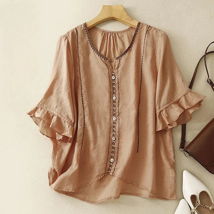 Versatile women's blouse: an embroidered V-neck top with ruffled 3/4 sleeves, ideal for casual chic spring looks.