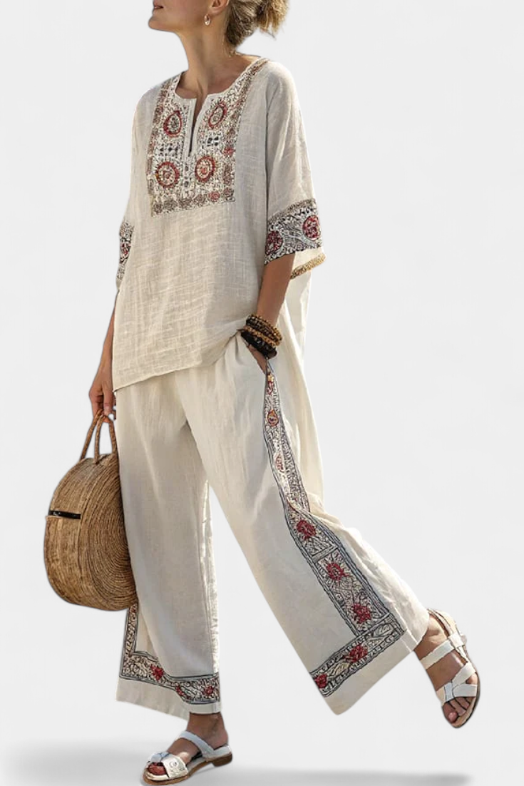 Elegant women's embroidered floral blouse & wide trousers set for spring/summer; comfortable two-piece outfit.