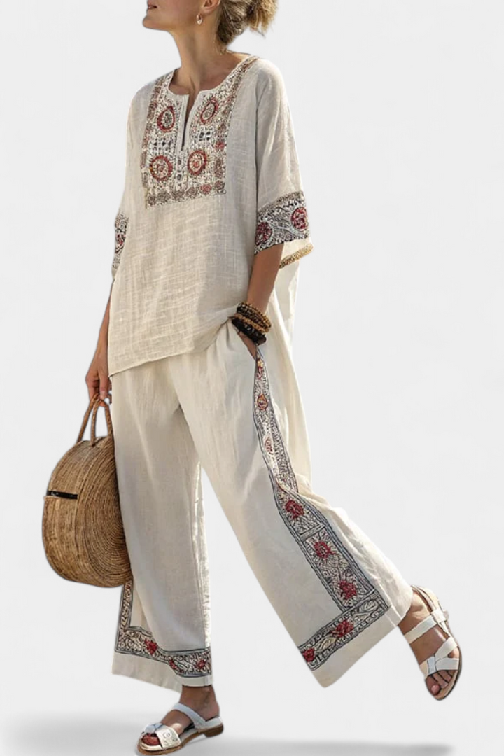 Elegant women's embroidered floral blouse & wide trousers set for spring/summer; comfortable two-piece outfit.