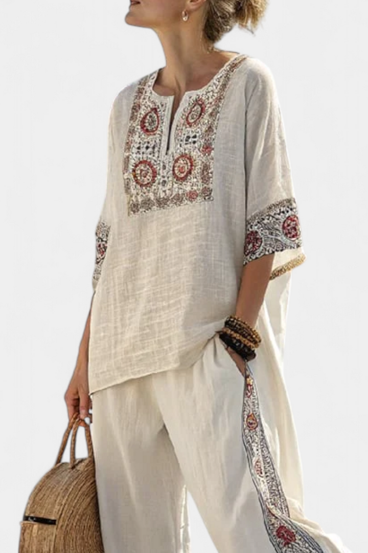 Boho chic women's two-piece set featuring a sophisticated embroidered floral blouse & relaxed wide-leg trousers.