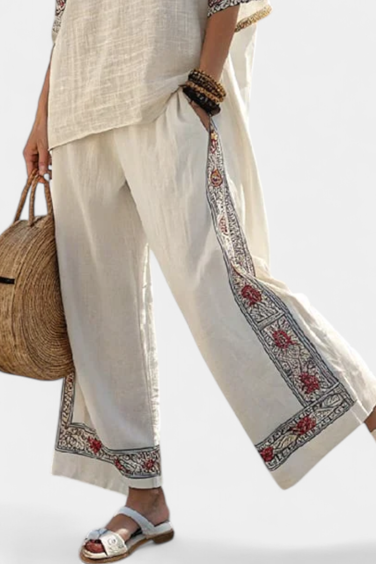 Comfortable women's spring/summer set with an embroidered floral blouse & flowing wide trousers; elegant and stylish.