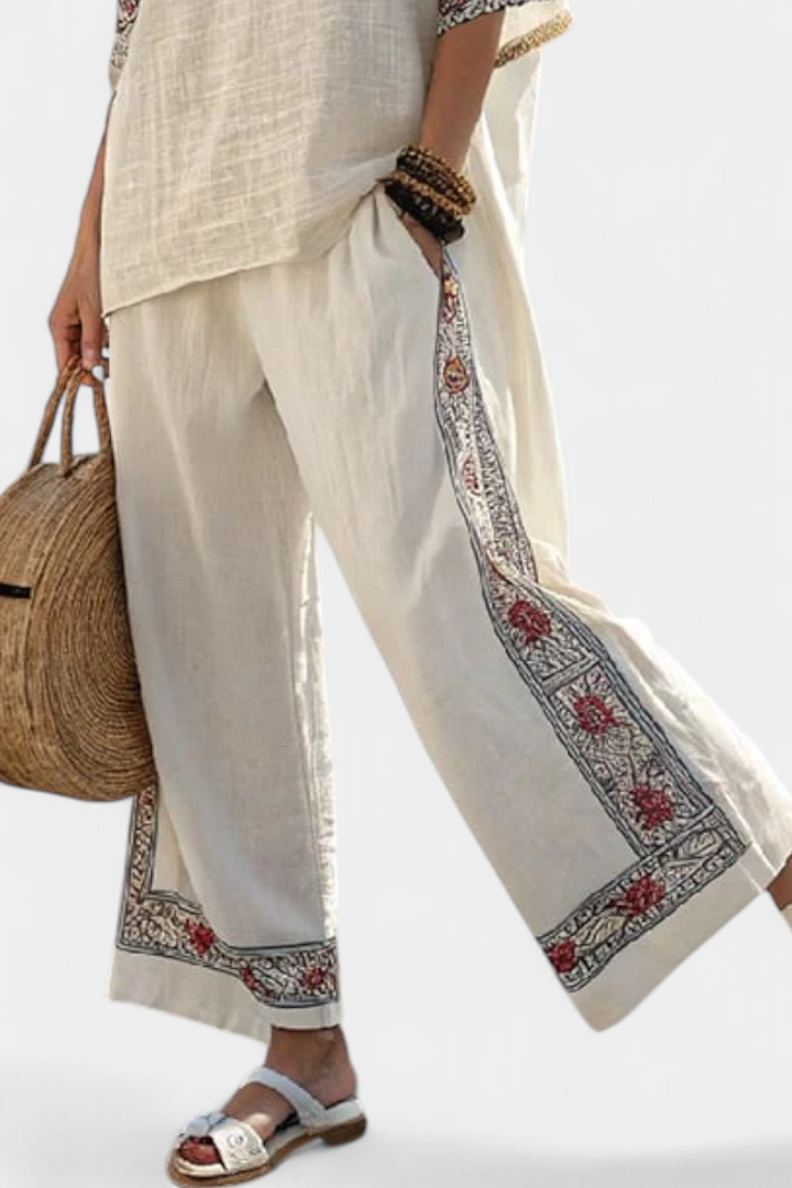 Comfortable women's spring/summer set with an embroidered floral blouse & flowing wide trousers; elegant and stylish.