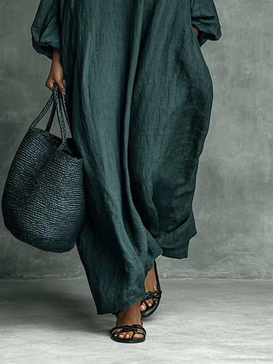 Modest women's maxi dress, intricately embroidered with floral pattern. High neck, long sleeve, relaxed fit for comfort.