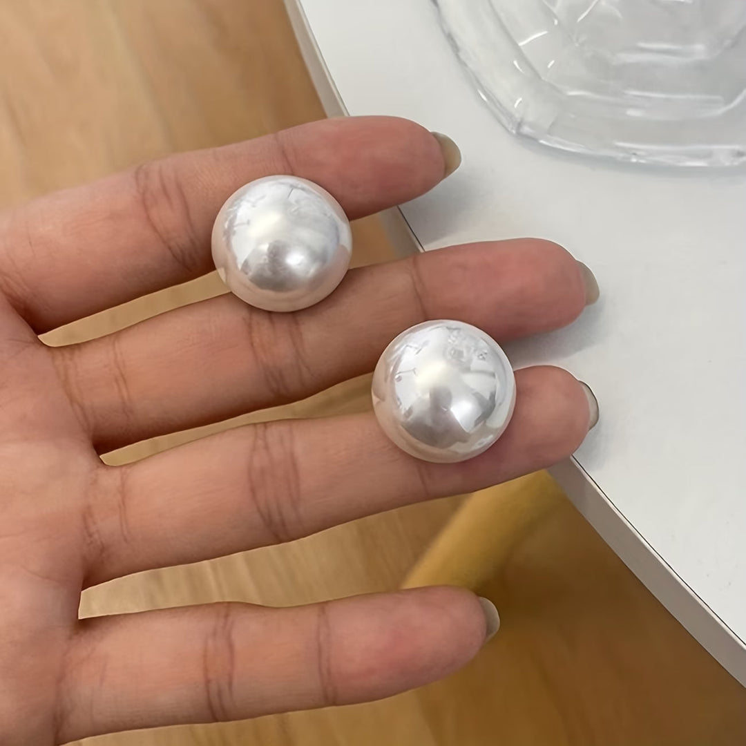 Classic women's pearl stud earrings. Chic statement accessories for everyday elegance & sophisticated style.
