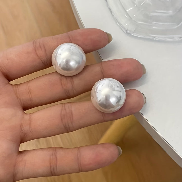 Classic women's pearl stud earrings. Chic statement accessories for everyday elegance & sophisticated style.