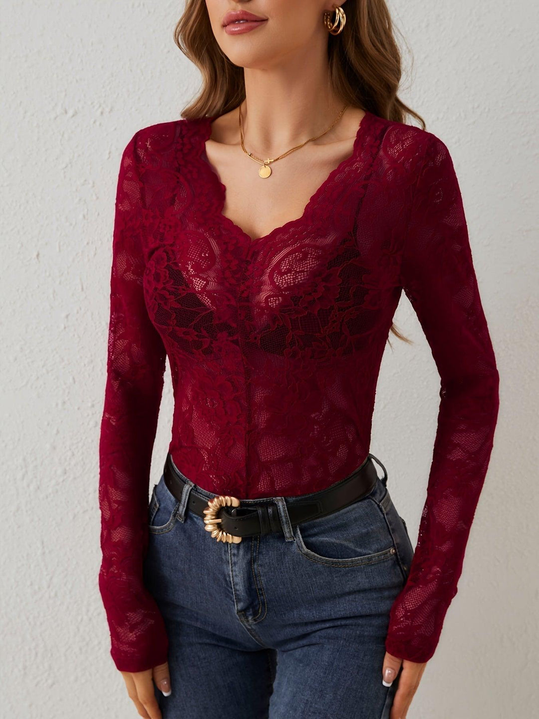 Elegant women's fitted black lace V-neck sheer long sleeve top, perfect for a night out.
