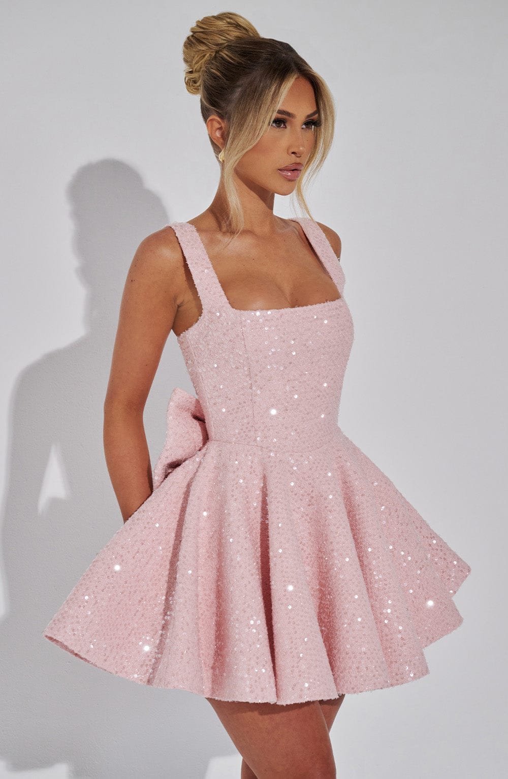 Sleeveless women's flared mini dress with charming bow detail, a sophisticated choice for parties.