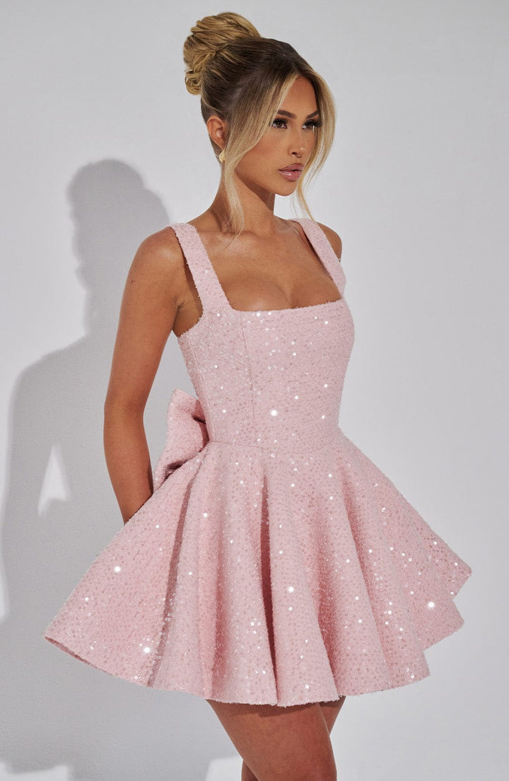 Sleeveless women's flared mini dress with charming bow detail, a sophisticated choice for parties.