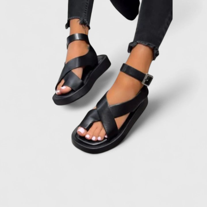 Women's elegant flat sandals, offering comfortable and versatile spring/summer footwear.