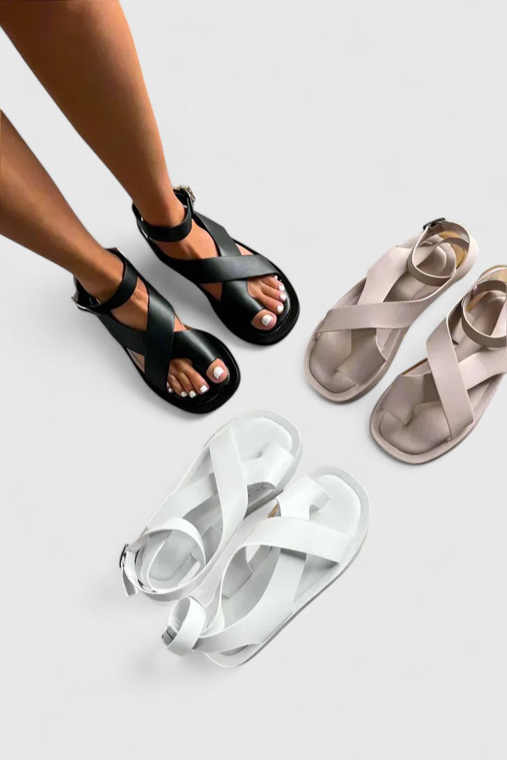 Elegant women's flat sandals, versatile for casual or dressy summer outfits.