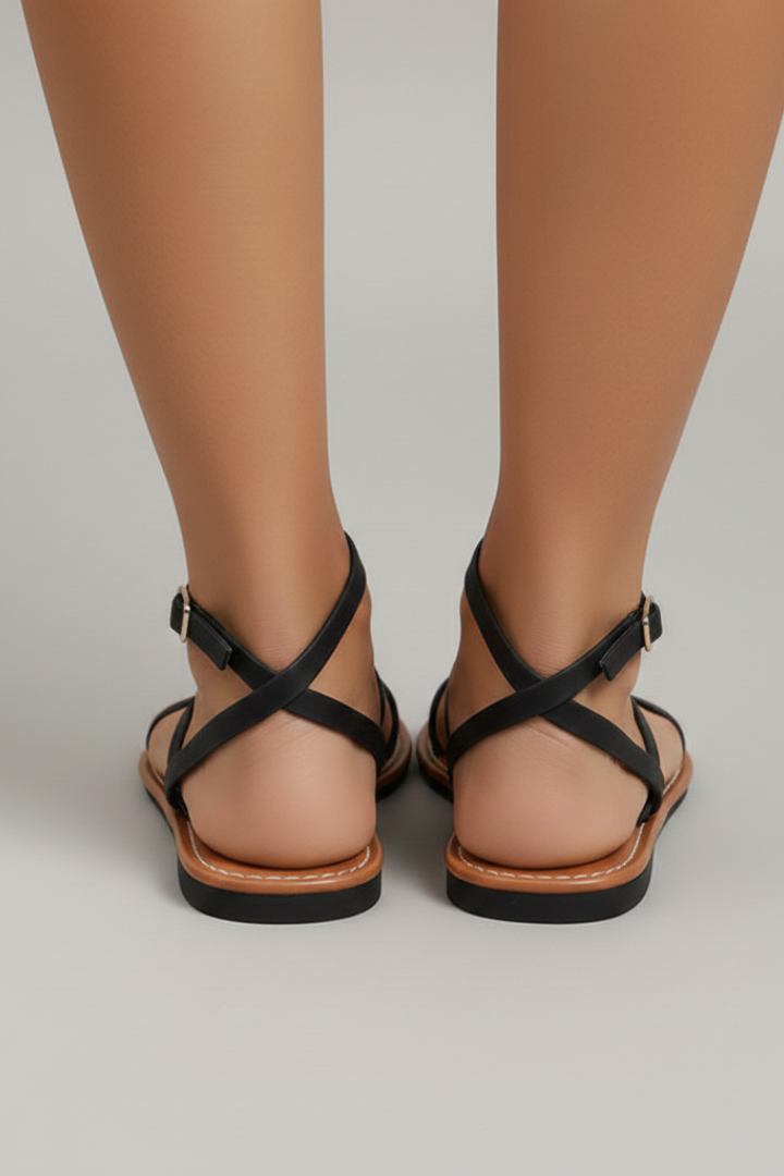 Stylish women's open-toe flat sandals, featuring a secure ankle strap and an elegant multi-strappy design for summer.