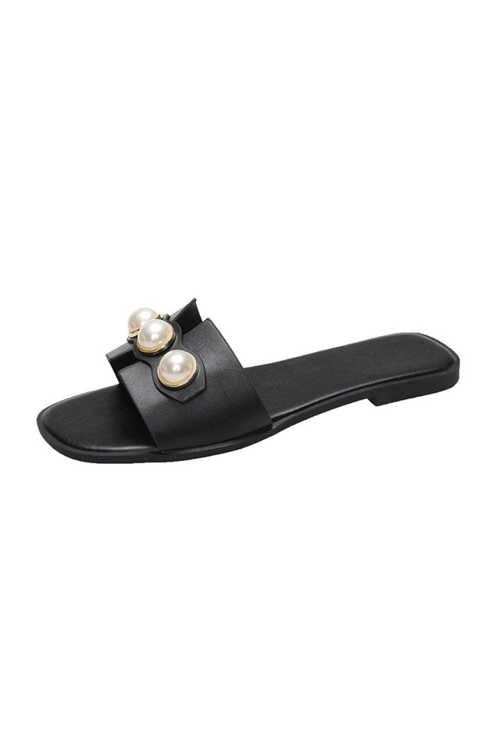 Chic women's slip-on flat sandals, featuring elegant pearl embellishments for comfortable summer wear.