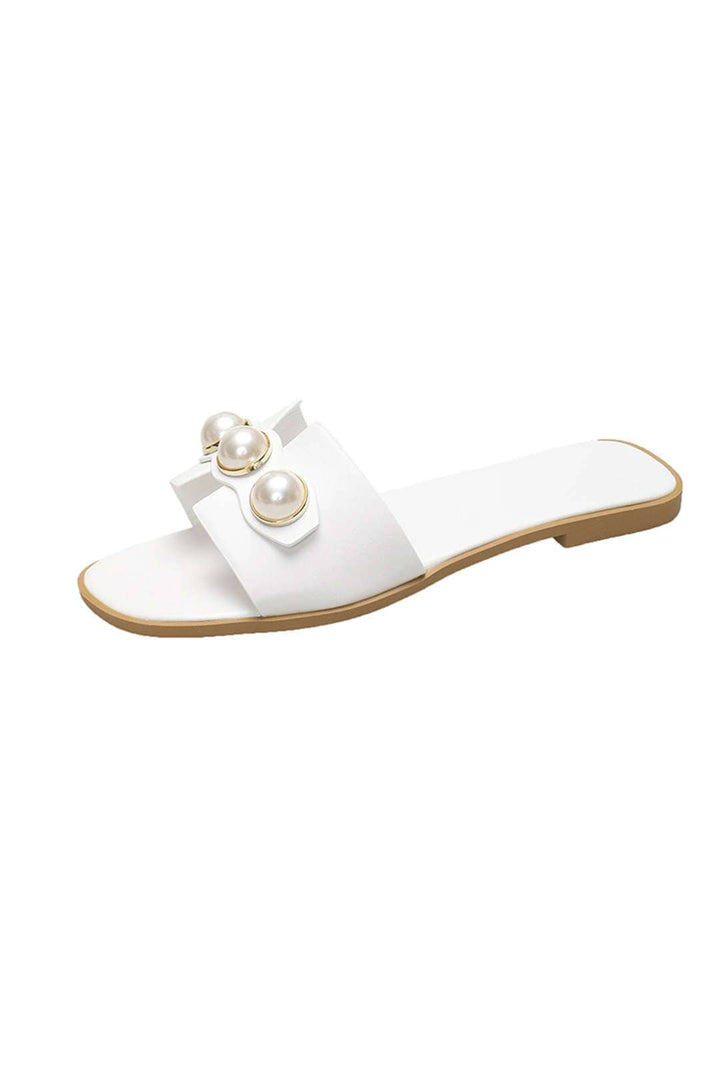 Women's stylish flat slides with delicate pearl detailing, ideal casual or vacation footwear.