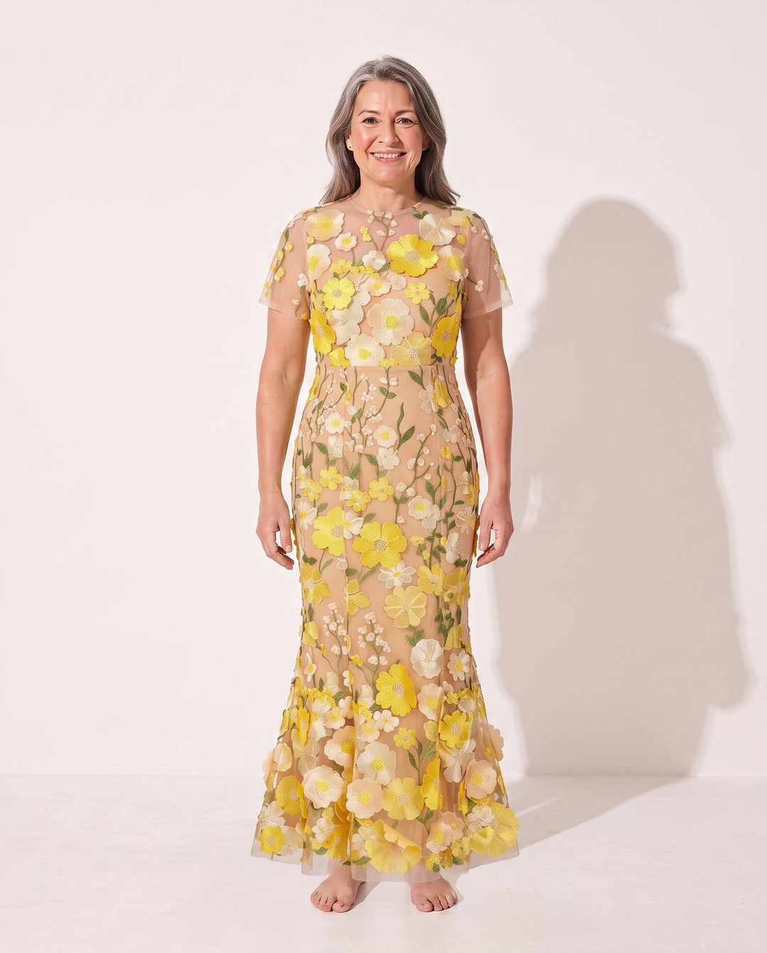 Close-up of women's autumn midi dress, showcasing delicate floral appliqué details & elegant sheer sleeves.