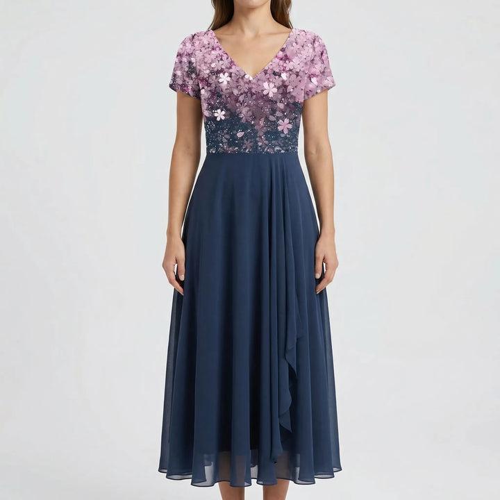 Lightweight women's summer midi dress with vibrant floral V-neck bodice and short sleeves. Perfect for garden parties.