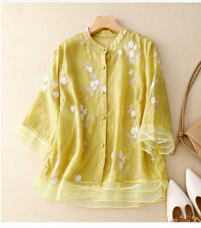 Women's floral button-down blouse showcasing a sophisticated print and a flattering layered hem.