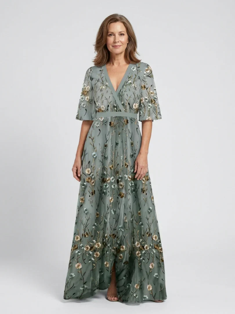Chic v-neck maxi dress featuring delicate floral embroidery, ideal for summer events.