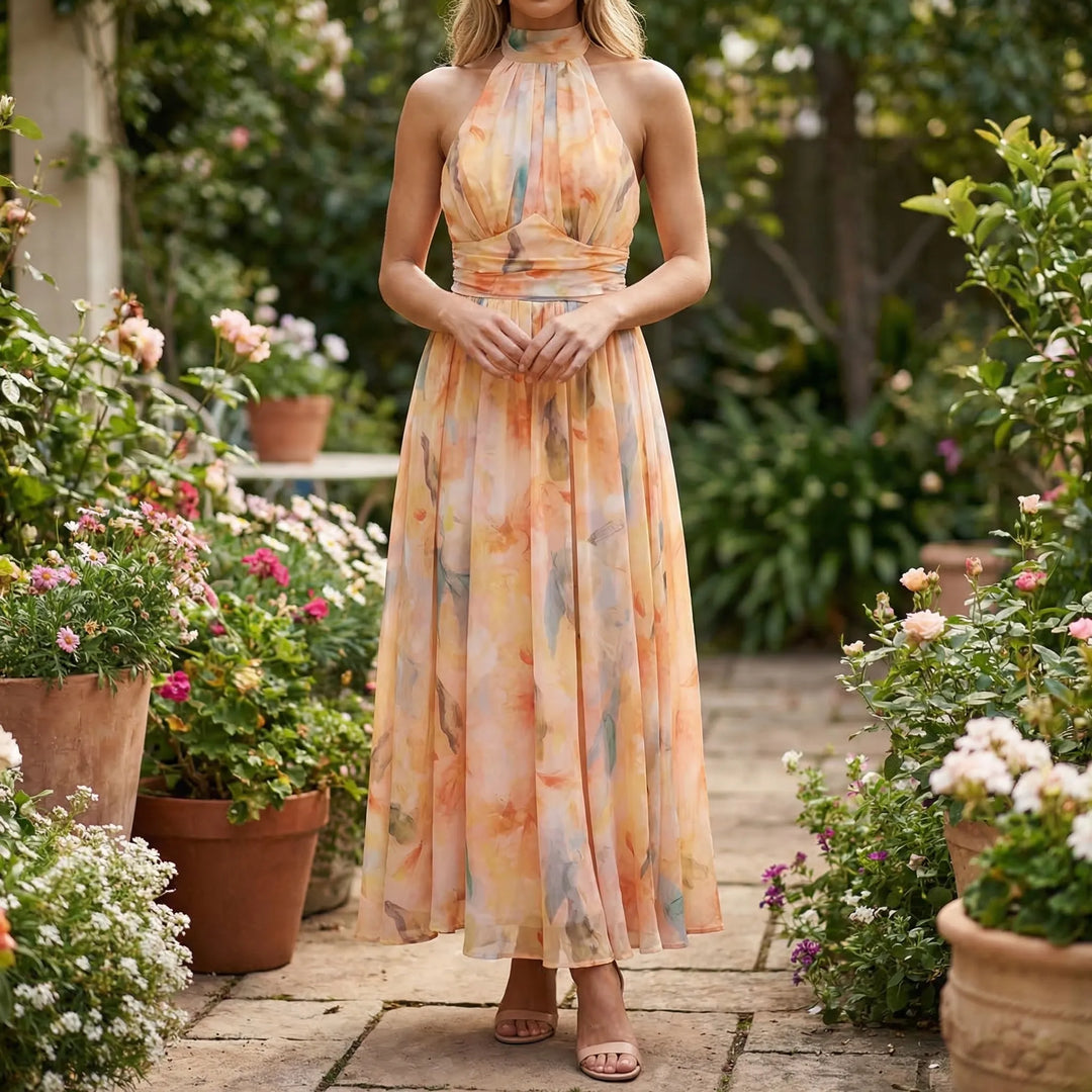 Elegant women's floral halter-neck maxi dress in peach coral, perfect for summer occasions. Flowy, sleeveless design.