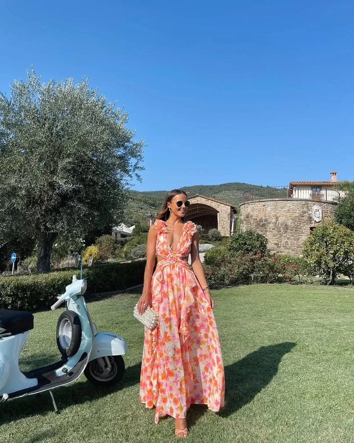Stylish sleeveless floral maxi dress with ruffles & cut-out detail, ideal for parties.