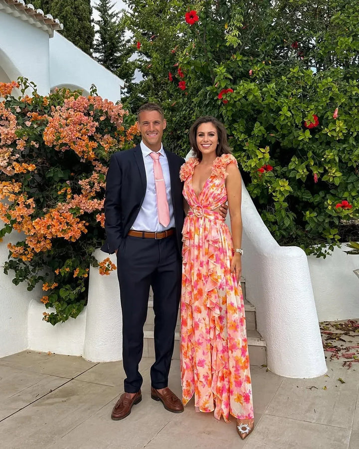 Chic floral ruffle maxi dress with waist cut-outs, suitable for wedding guests & vacation.