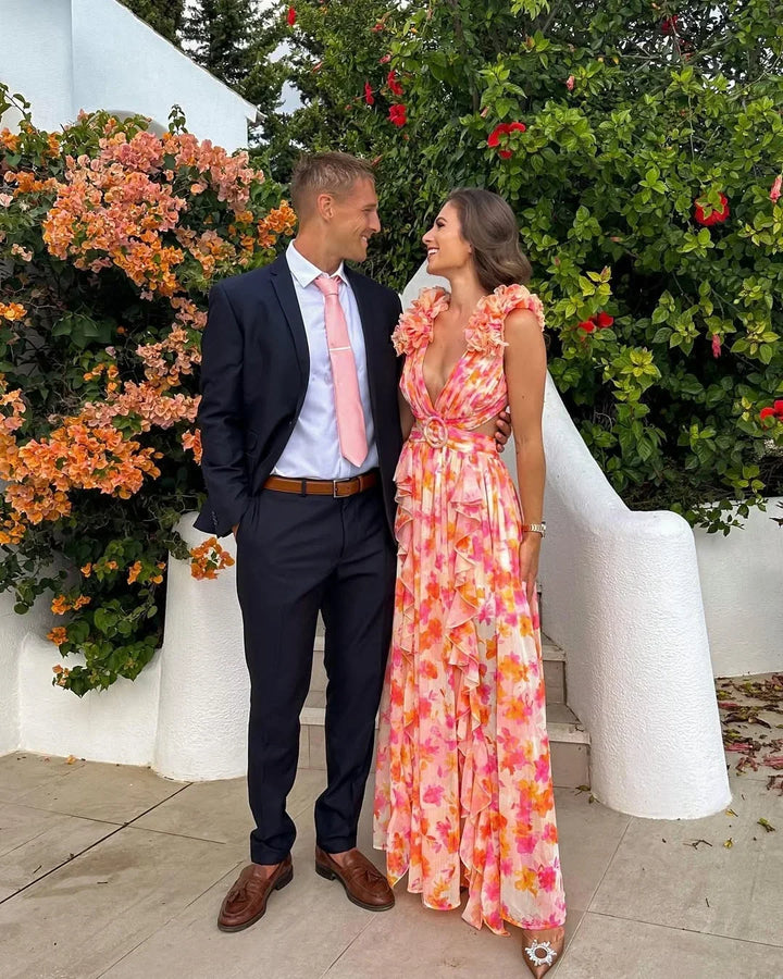 Beautiful sleeveless floral maxi dress with v-neck, ruffles & side cut-outs for women.