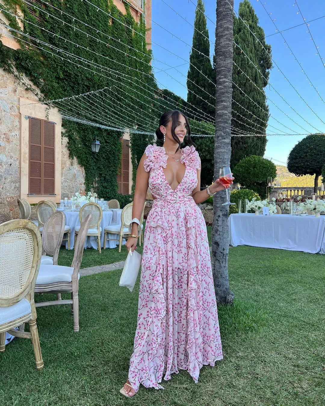 Occasion wear floral maxi dress for women, with ruffles, cut-outs, and a flowing design.