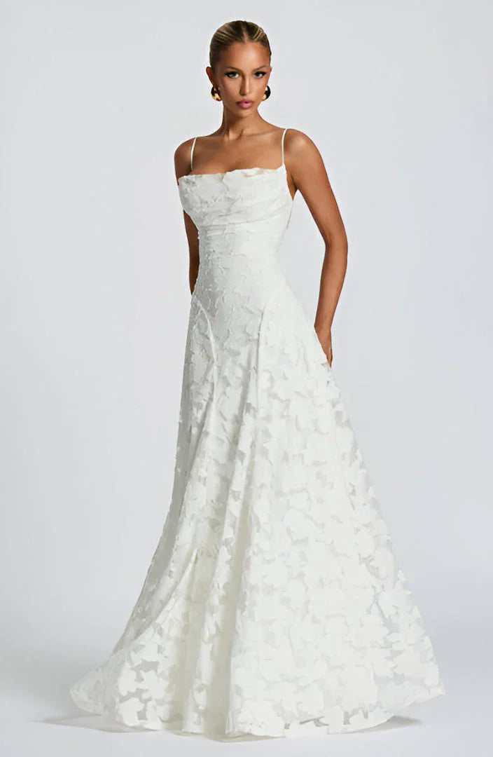 Long women's floral dress with spaghetti straps, suitable for elegant evening wear.