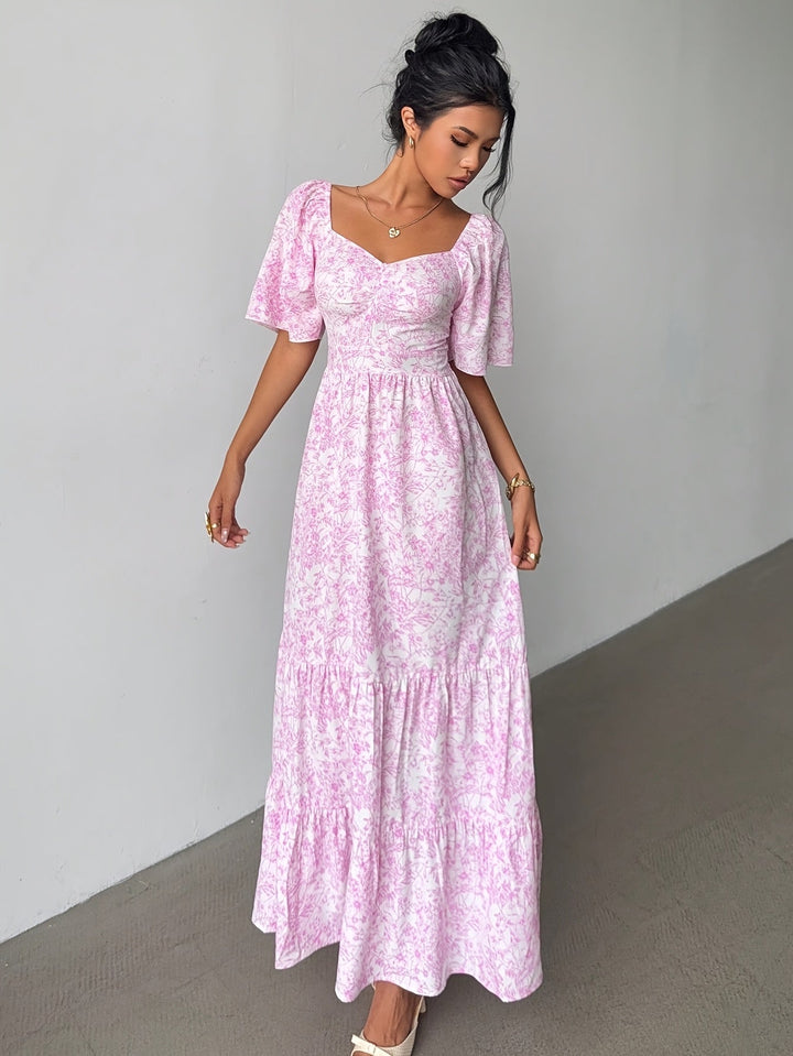 Elegant women's floral maxi dress with sweetheart neckline & tiered skirt, perfect for summer parties.