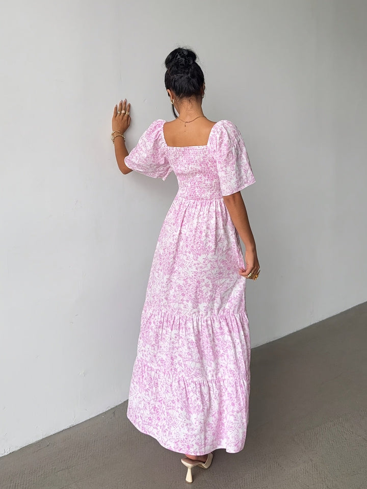 Stylish women's tiered maxi dress featuring a beautiful floral print and sweetheart neck, great for summer.