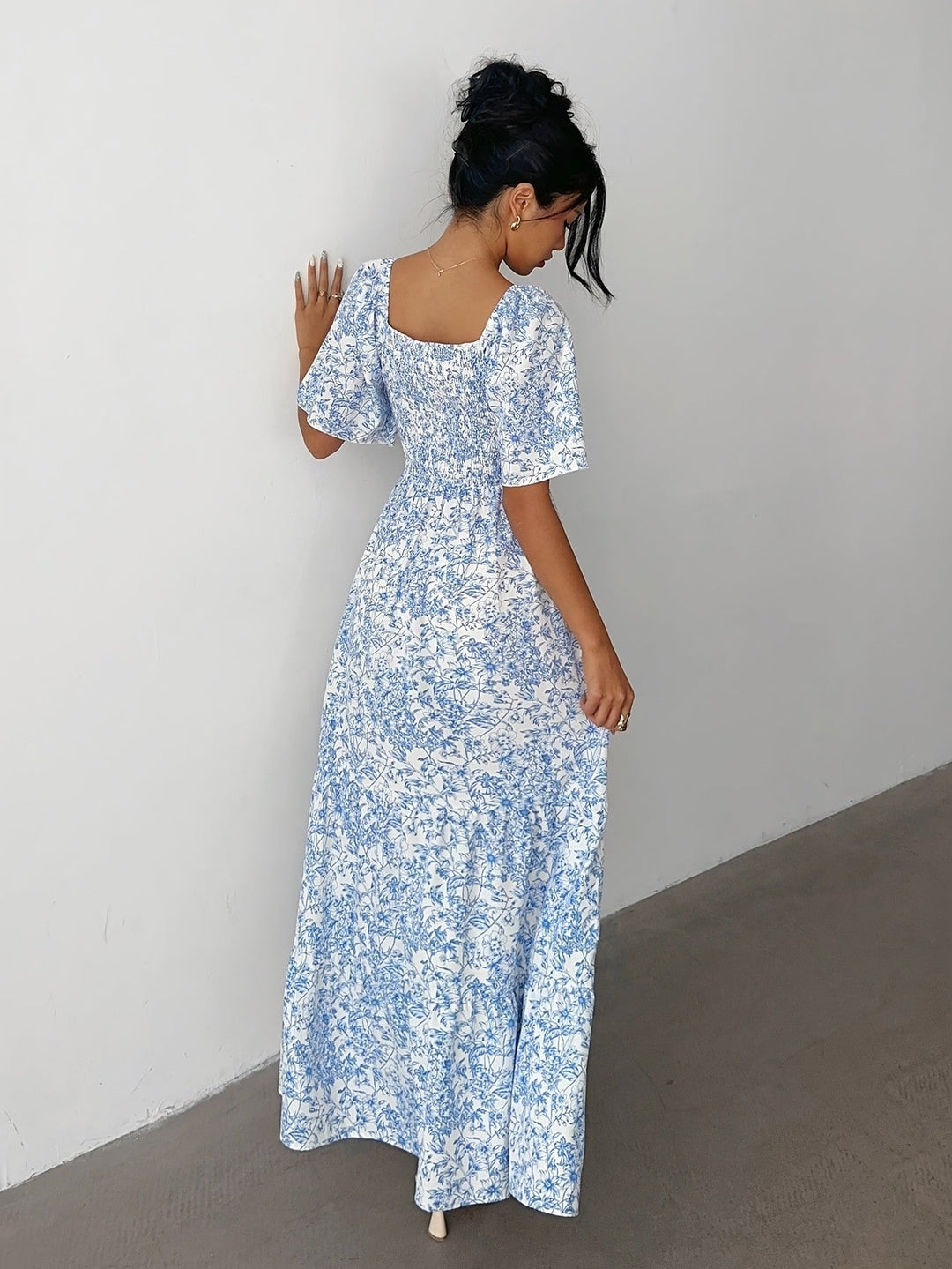 Women's long tiered dress with a vibrant floral pattern and flattering sweetheart neckline for elegant fashion.