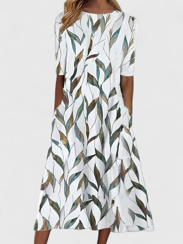 Women's elegant floral midi dress, ideal for summer occasions. Flowy design with round neck, perfect for a chic look.