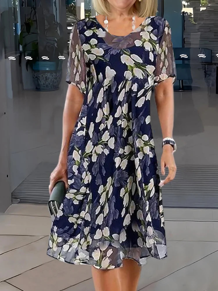 Elegant women's floral midi dress with a round neck and short sleeves, perfect for spring and summer fashion.
