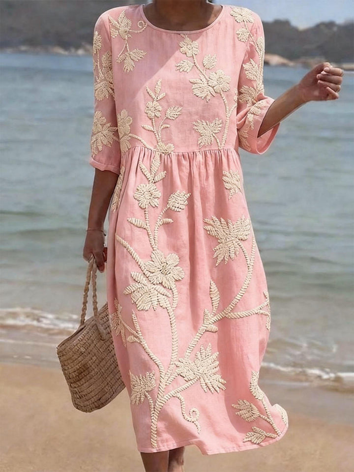 Chic women's embroidered floral midi dress with a round neck, ideal for elegant summer comfort and fashion.