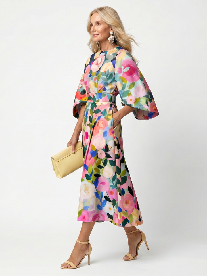 Close-up of the elegant floral pattern on a women's midi dress, showcasing wide sleeves & comfortable fabric.