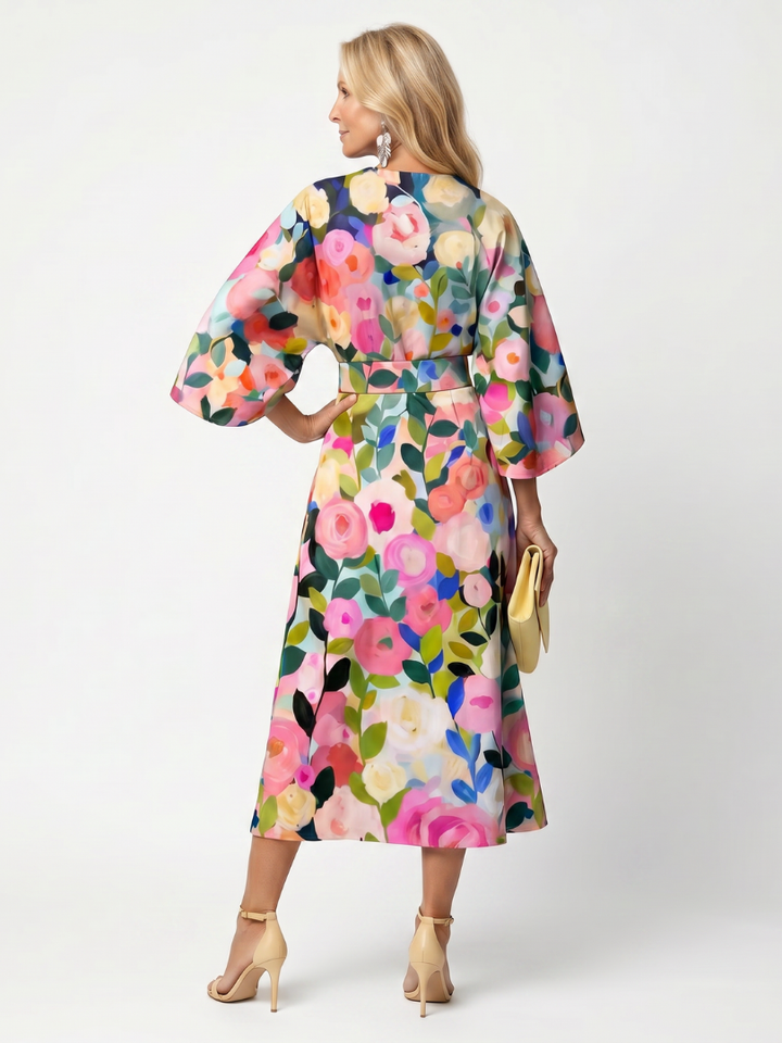 Woman wearing a comfortable floral midi dress with wide sleeves, ideal for a casual summer day out.